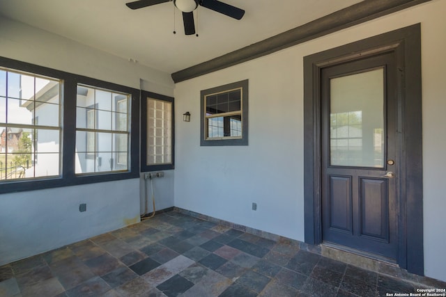 doorway to property with a patio and ceiling fan