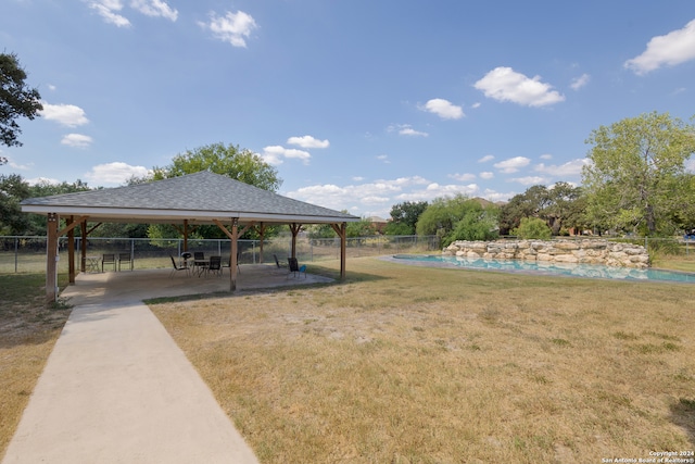 surrounding community featuring a patio, a gazebo, a yard, and a swimming pool