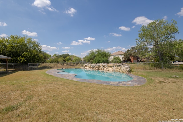 view of pool with a lawn