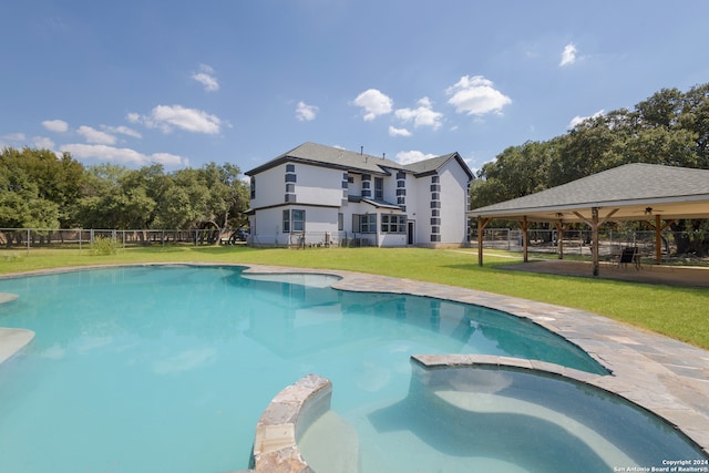 view of pool with a patio, an in ground hot tub, and a lawn