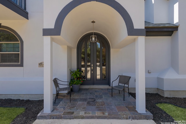 entrance to property featuring french doors and a patio area