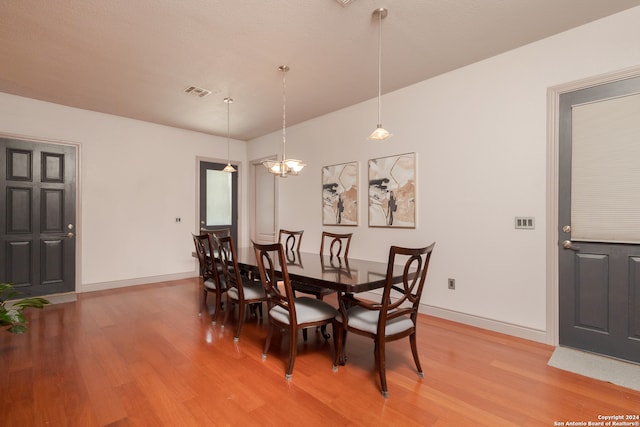 dining room featuring an inviting chandelier and wood-type flooring