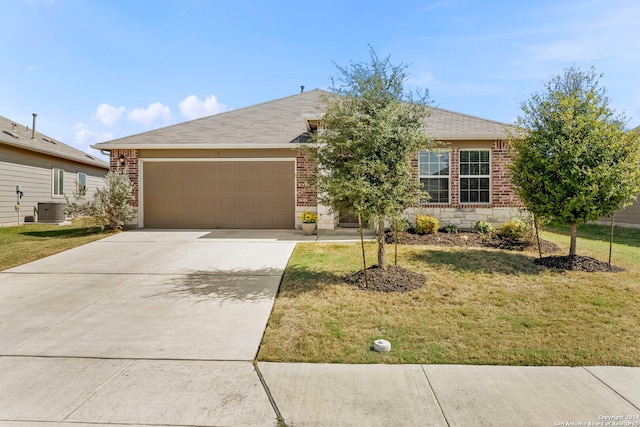 ranch-style house featuring a front lawn, central air condition unit, and a garage