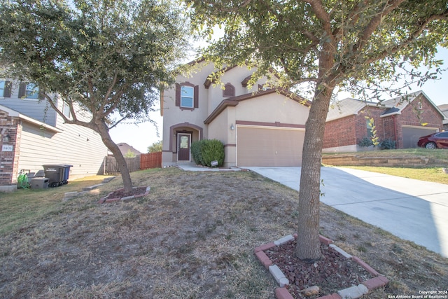 view of front of home featuring a front yard and a garage