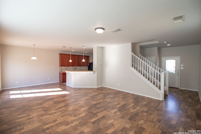 unfurnished living room featuring dark hardwood / wood-style flooring