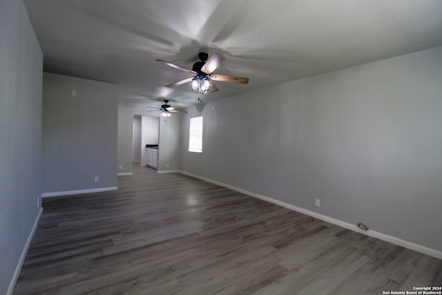 unfurnished room with ceiling fan and hardwood / wood-style flooring