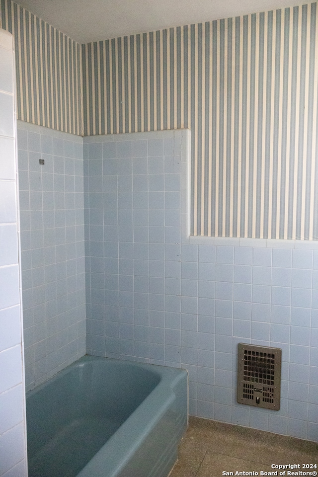 bathroom featuring a tub to relax in