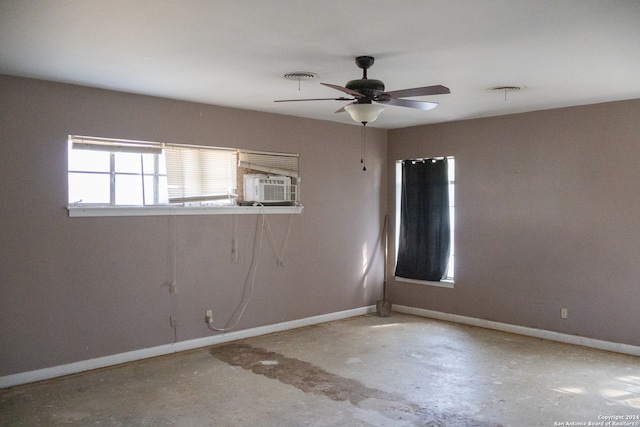 unfurnished room featuring ceiling fan and concrete floors