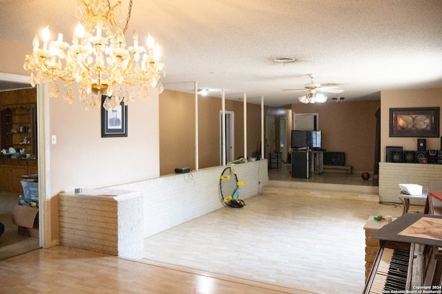 reception area with ceiling fan with notable chandelier