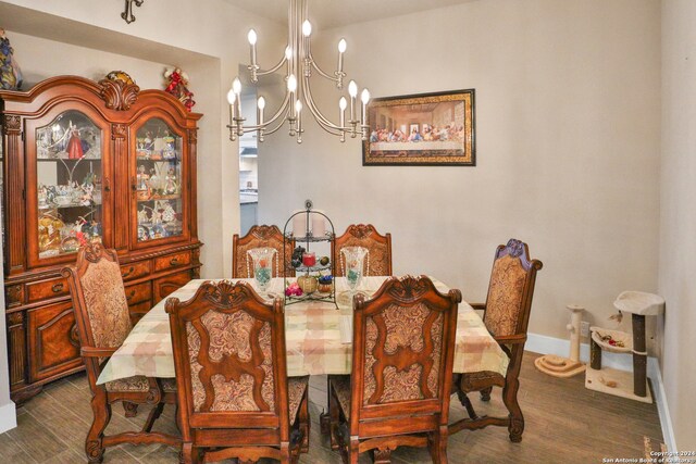 dining room with a notable chandelier and dark hardwood / wood-style flooring