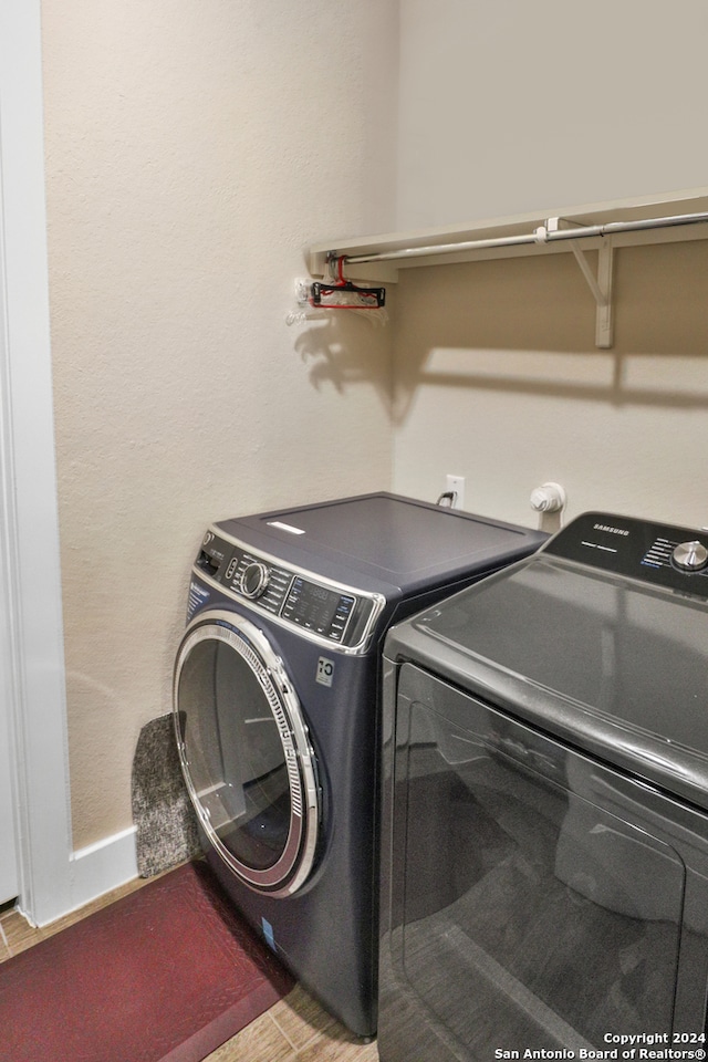 clothes washing area with separate washer and dryer