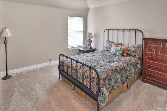 carpeted bedroom featuring vaulted ceiling