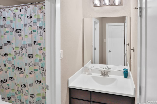 bathroom with vanity and curtained shower