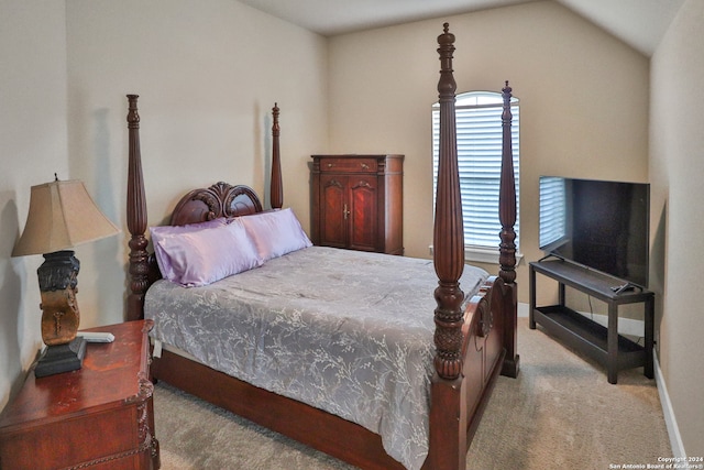 carpeted bedroom featuring vaulted ceiling