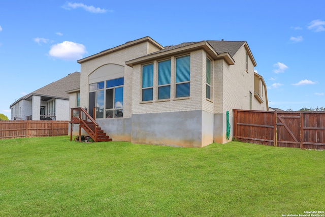 back of property featuring a yard