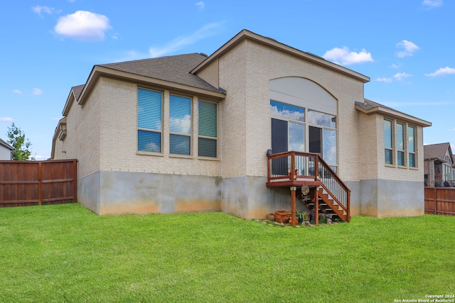 back of property with a lawn