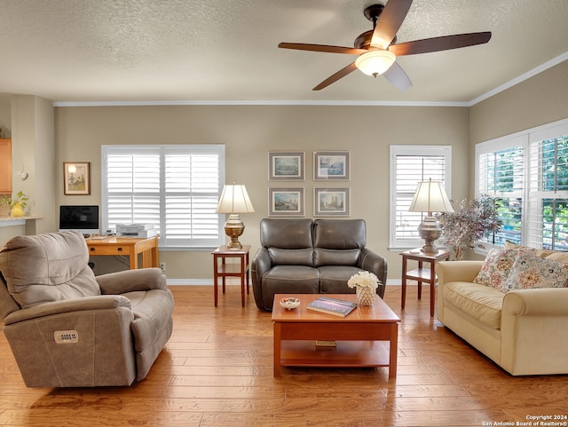 living room featuring ceiling fan, light wood-type flooring, crown molding, and a healthy amount of sunlight