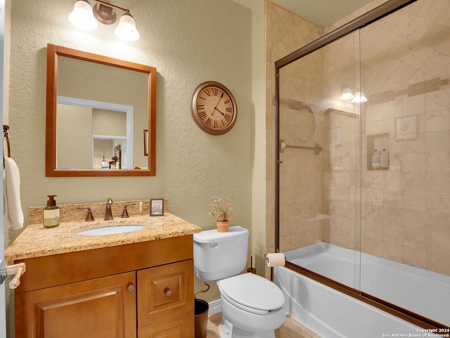 full bathroom featuring shower / bath combination with glass door, vanity, and toilet