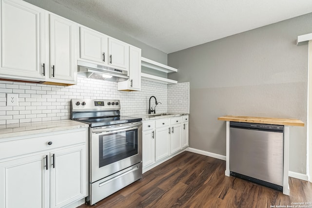 kitchen featuring white cabinets, light stone countertops, dark hardwood / wood-style flooring, stainless steel appliances, and sink