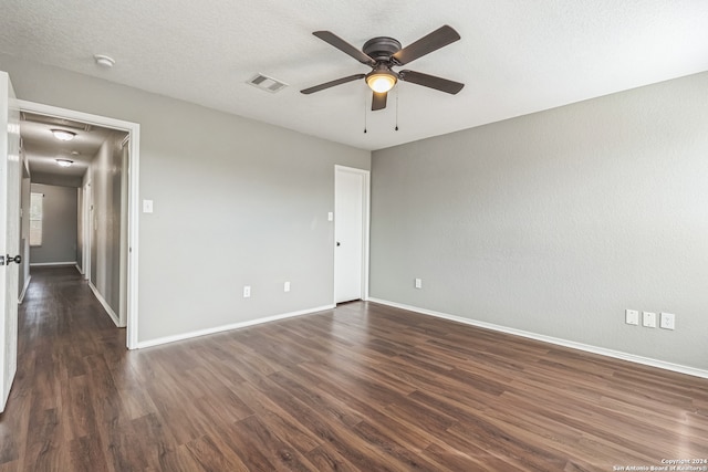 unfurnished room featuring a textured ceiling, dark hardwood / wood-style floors, and ceiling fan