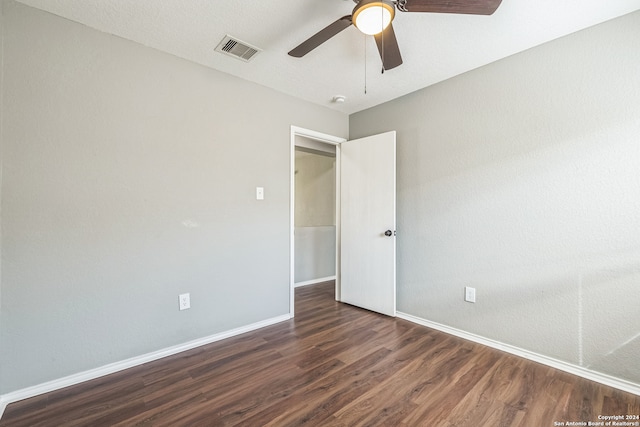 unfurnished room featuring ceiling fan and dark hardwood / wood-style floors