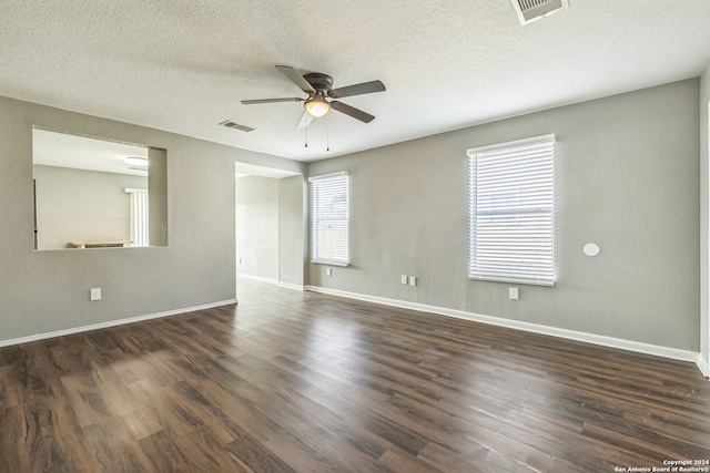 spare room featuring a textured ceiling, dark hardwood / wood-style floors, and ceiling fan