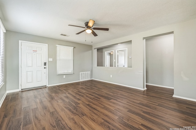 interior space featuring a textured ceiling, dark hardwood / wood-style floors, and ceiling fan