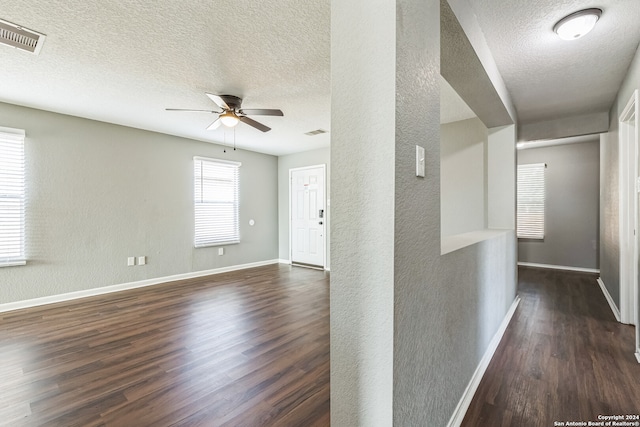 interior space featuring a textured ceiling, dark hardwood / wood-style floors, and ceiling fan