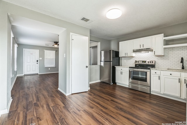 kitchen with ceiling fan, white cabinets, sink, dark wood-type flooring, and stainless steel appliances