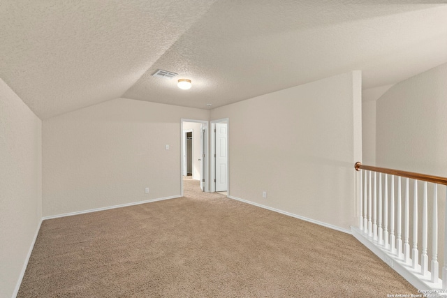 bonus room featuring carpet floors, vaulted ceiling, and a textured ceiling