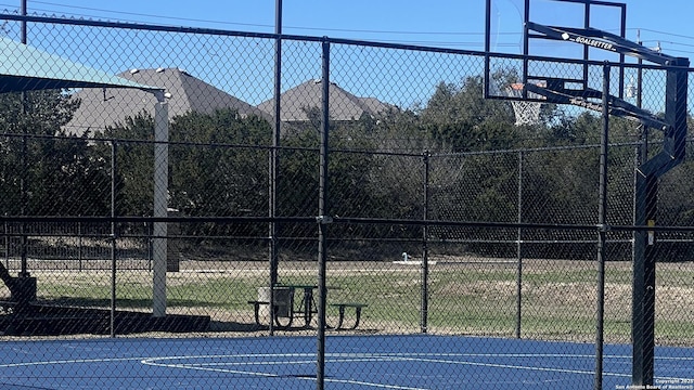 view of basketball court featuring community basketball court and fence