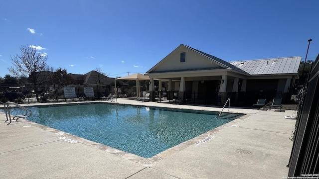 pool with fence and a patio