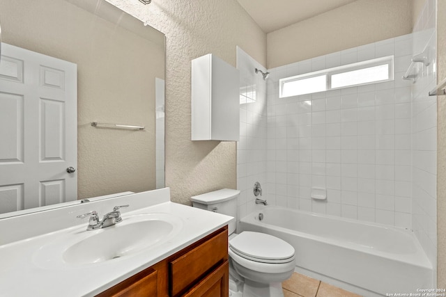 full bathroom with tiled shower / bath, vanity, toilet, and tile patterned floors