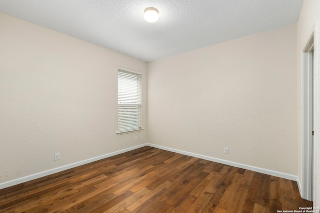 unfurnished room featuring dark wood-type flooring