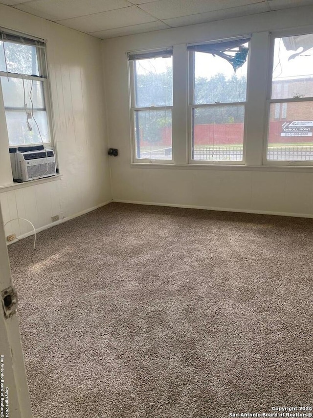 2019 Martin Luther King Dr, San Antonio, TX 78203 - unfurnished room featuring cooling unit, baseboards, plenty of natural light, and carpet floors