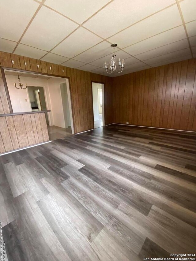 2019 Martin Luther King Dr, San Antonio, TX 78203 - empty room with wood finished floors, an inviting chandelier, and a drop ceiling