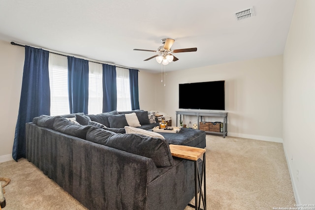 living room with light colored carpet and ceiling fan