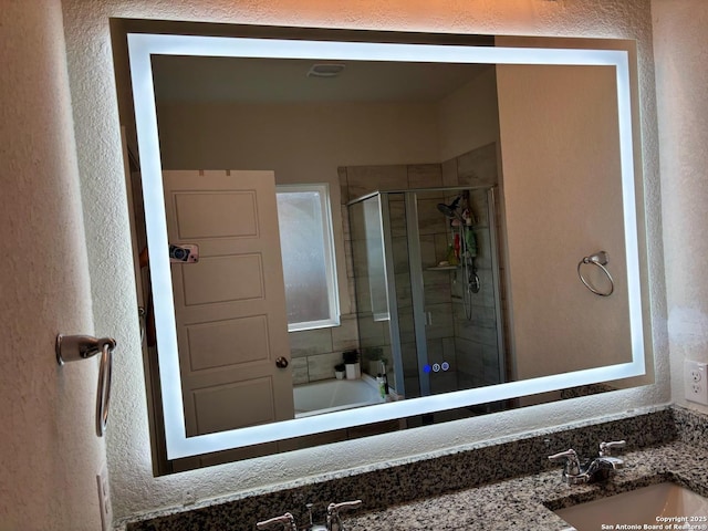 3443 Iron Cyn, Bulverde, TX 78163 - full bathroom with a shower stall, a textured wall, and vanity