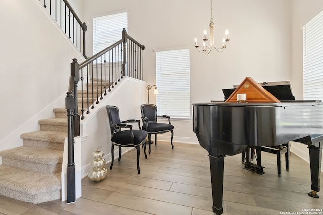 interior space with a high ceiling, a chandelier, and wood-type flooring