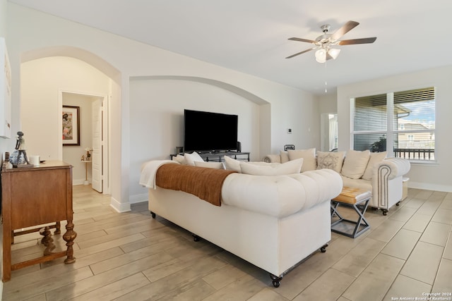 living room with light wood-type flooring and ceiling fan