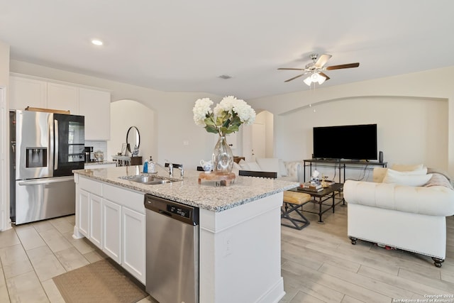 3443 Iron Cyn, Bulverde, TX 78163 - kitchen with a ceiling fan, a sink, arched walkways, stainless steel appliances, and white cabinetry