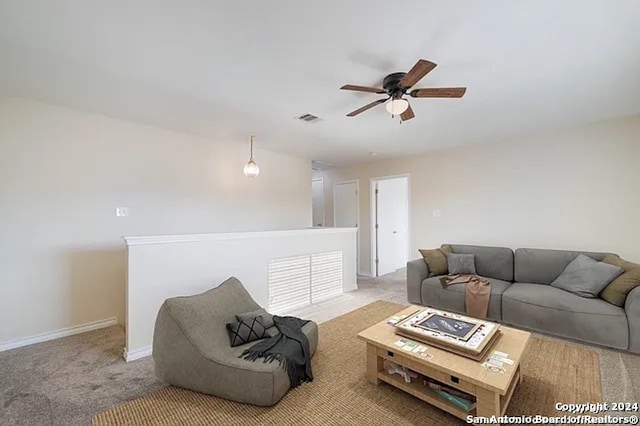 carpeted living room featuring ceiling fan