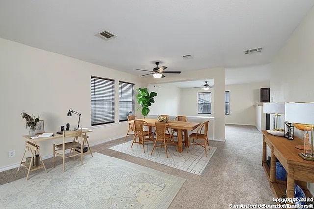 dining room featuring a wealth of natural light, ceiling fan, and light colored carpet