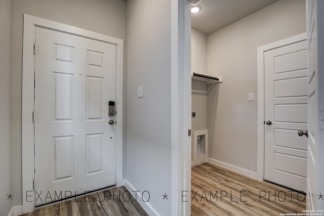 interior space with hookup for an electric dryer and hardwood / wood-style flooring