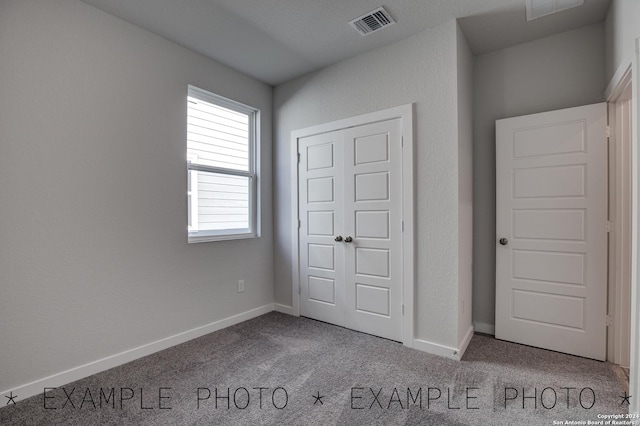 unfurnished bedroom with carpet flooring and a closet