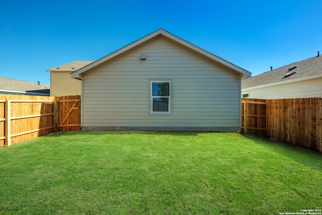 back of house with a yard