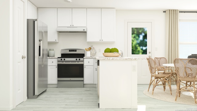 kitchen featuring light hardwood / wood-style flooring, stainless steel appliances, light stone countertops, and white cabinetry