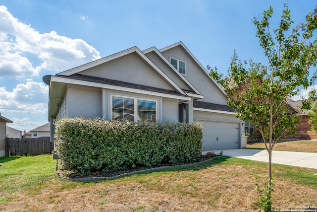 view of front facade featuring a front yard and a garage