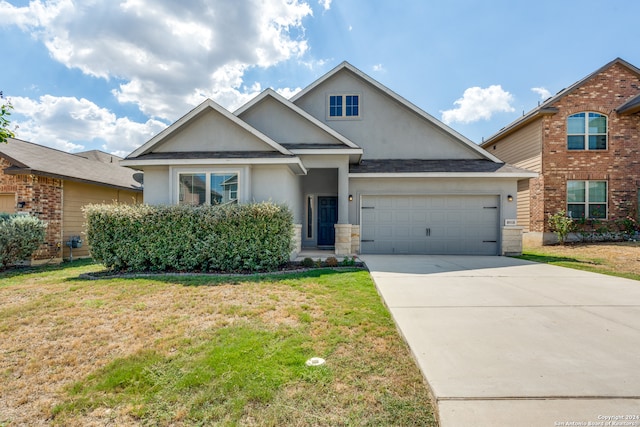 view of front of house with a garage and a front lawn