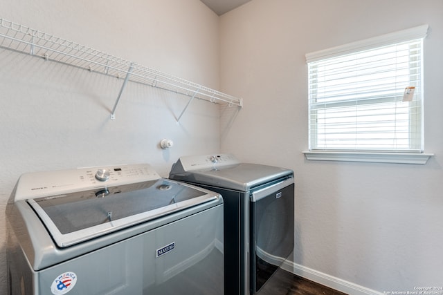 washroom featuring dark wood-type flooring and separate washer and dryer